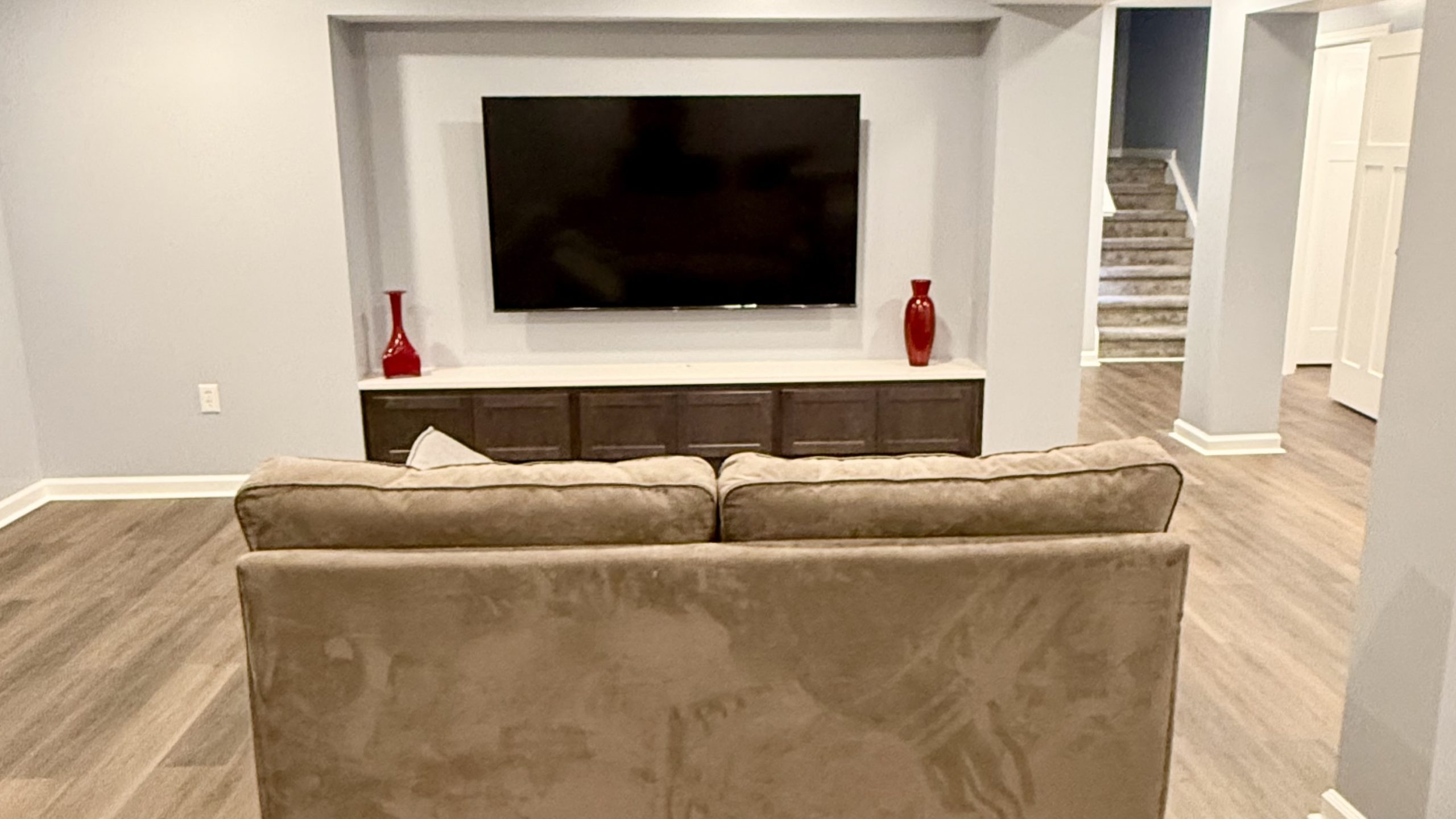Warm basement lounge with media wall designed for winter comfort.